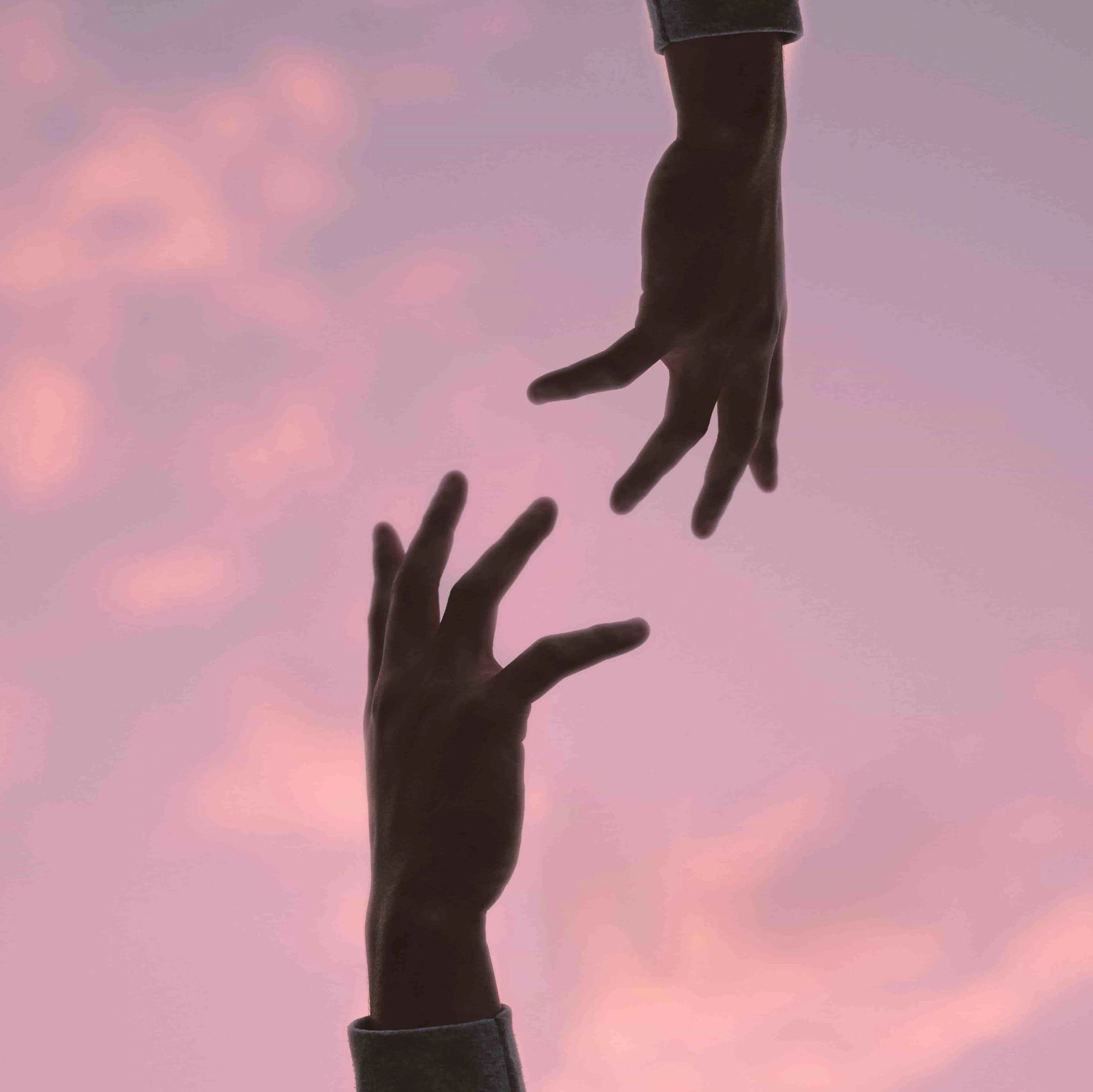 two hands reaching for each other