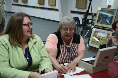 Two volunteers work the door for another fun play for community theatre groups.