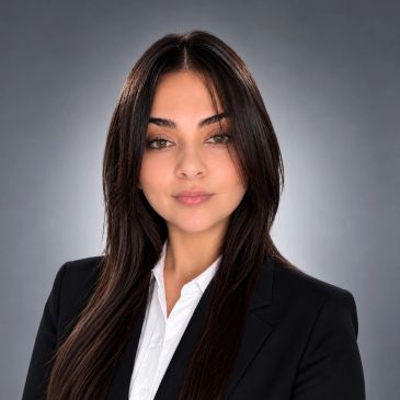 Professional headshot of a confident young woman.