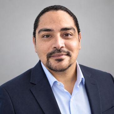 Professional man in suit with neutral background.