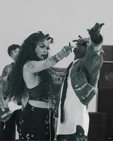 Energetic black-and-white scene of musicians passionately performing with intense expressions and dynamic gestures.