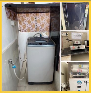 Compact washing machine, stove, fridge, and water purifier setup in a small space.
