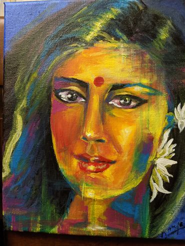 The red bindi anchors her calm gaze. The colors of Holi here are  revelation — of spirit, resilience