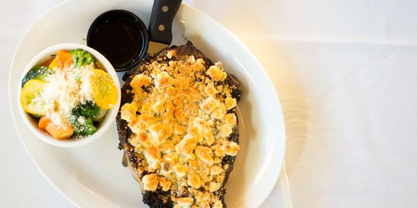 Close up shop of food in bowls and white plate