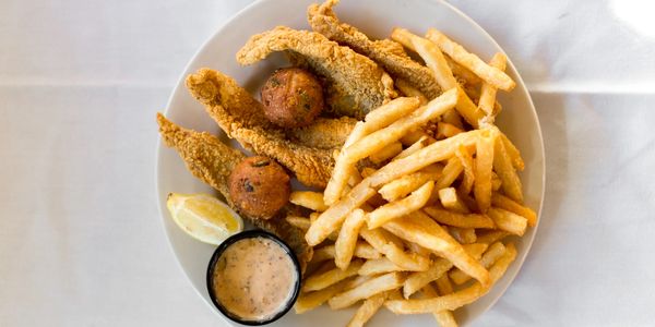 Top view of a plate full of foods with a white background