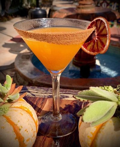 Vanilla Pumpkin martini on wooden table with mini pumpkins