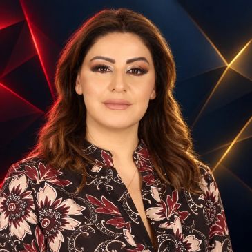 Confident woman with floral blouse against colorful geometric background.