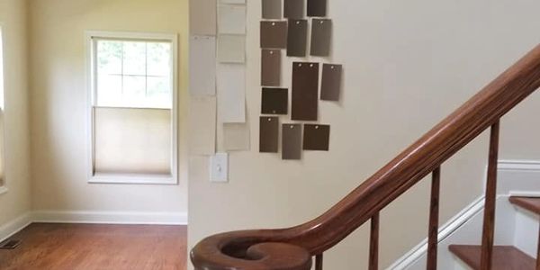 Making paint color decision for foyer walls, living room walls, staircase walls and an accent wall. Paint swatches. Benjamin Moore. Off whites and shades of brown.