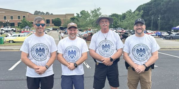 Four men in matching Northern Judges Support Task Force shirts.
