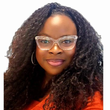 Woman with curly hair and clear glasses smiling warmly.