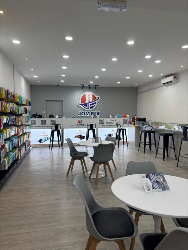Modern phone repair shop with organized accessories and seating.