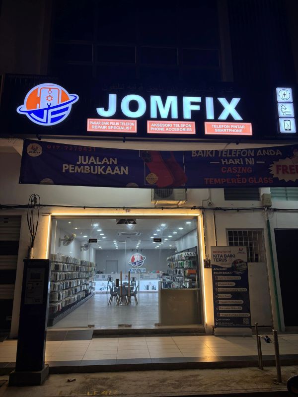 JOMFIX phone repair and accessories shop with bright signage and glass front.