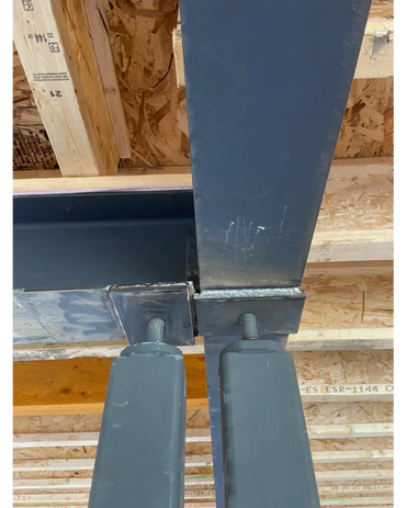 Steel beams and columns joined in a construction framework.