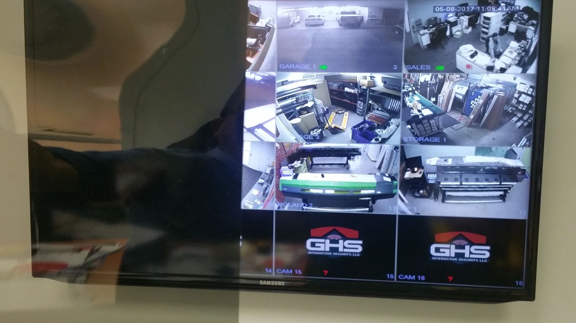 Security camera monitor showing multiple surveillance feeds inside a facility.