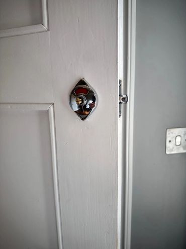 Indicator lock insalled on a public house bathroom door.