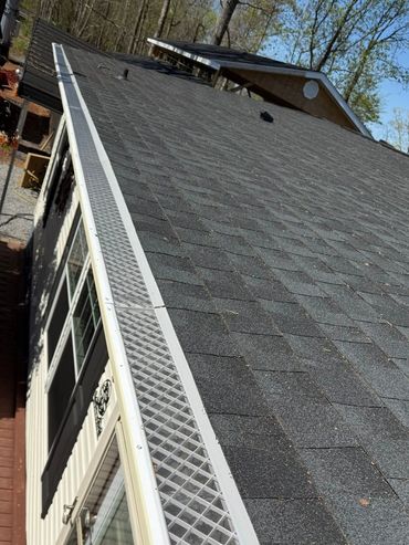 Seamless gutter system installed along roofline with gutter guard protection Knoxville TN