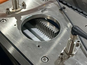 Metal machinery with cables and connectors attached. a rack and pinion driven actuator
