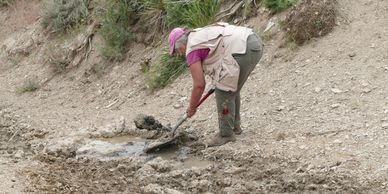 Aletha Dove working to create an area to hold water.