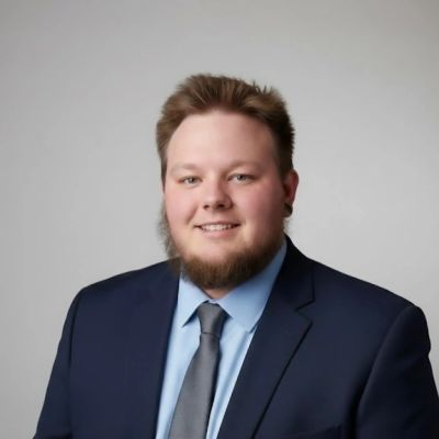Portrait of a man in a suit with a beard.