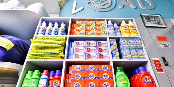 view of a shelf with laundry soaps and detergents