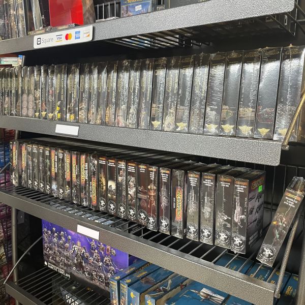 Shelves filled with boxed Warhammer 40k miniatures and expansions.