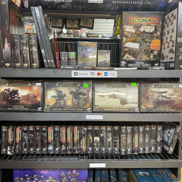 Shelves filled with Warhammer 40,000 and Necromunda model kits and accessories.