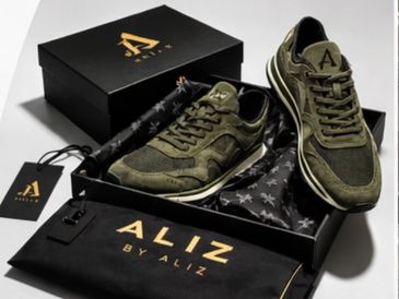 Olive green ALIZ sneakers displayed with branded box and dust bag.