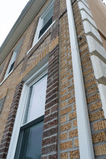 Newly installed concrete walkway along the side of a residential building. Clean lines and smooth finish emphasize expert concrete work for long-term durability in NYC environments.