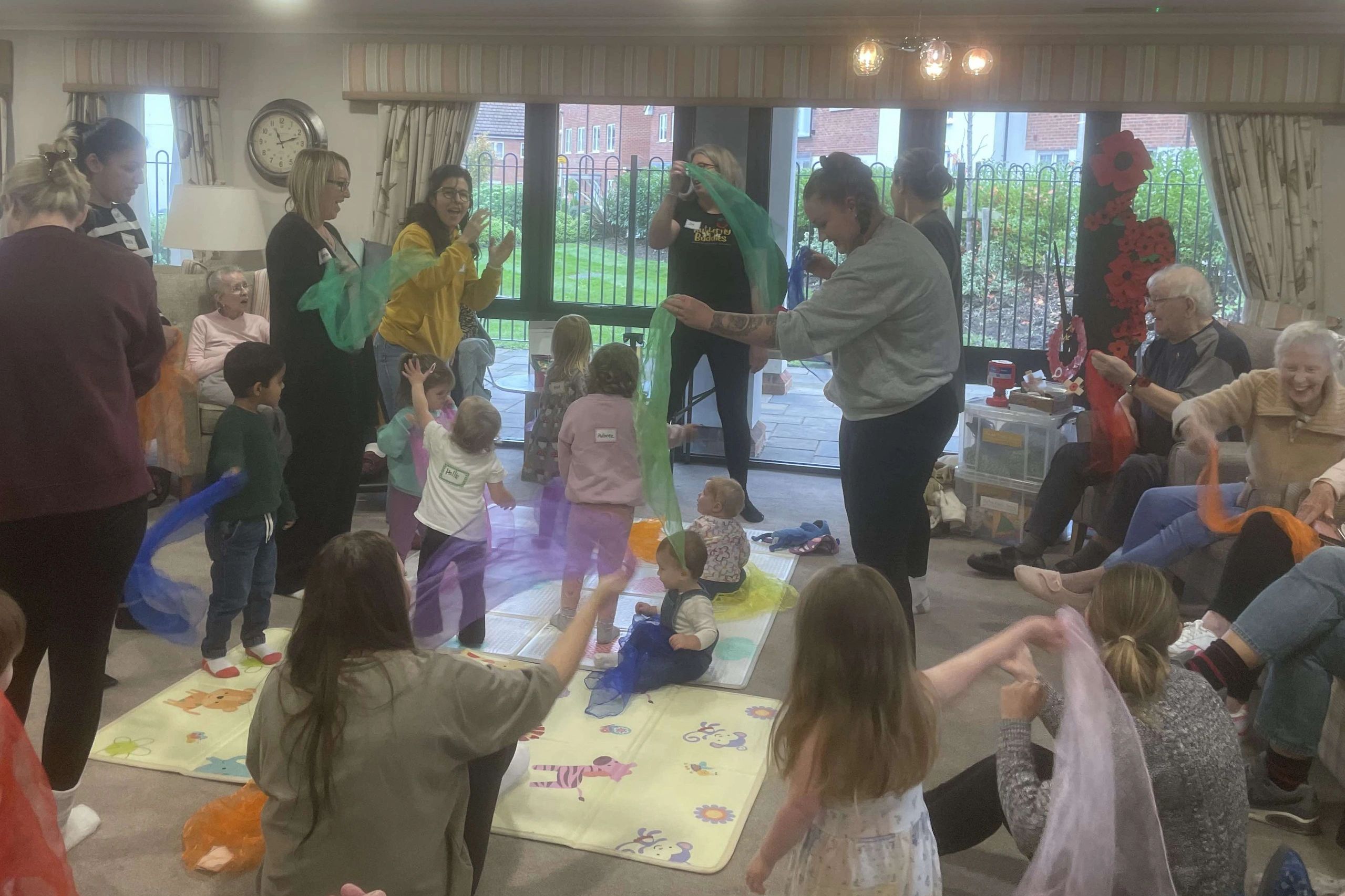 Parents and Carers joining in with scarf activities at the  baby and toddler group