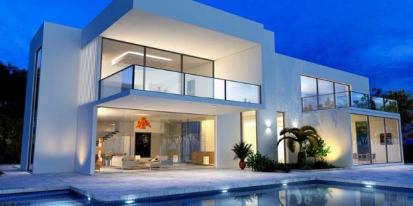 Modern luxurious house with pool at dusk.
