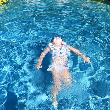 A girl relaxing in the swimming pool