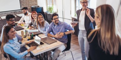 A group of young professionals engaged in a meeting in a modern office.