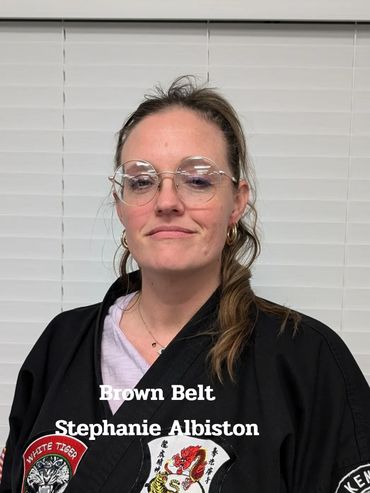 Stephanie Albiston wearing a black Kenpo Karate gi with brown belt recognition.