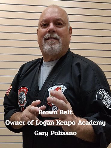 Gary Polisano, brown belt and owner of Logan Kenpo Academy, in martial arts attire.