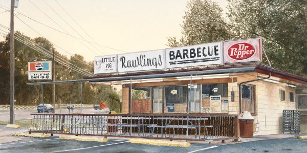 Small roadside barbecue joint with picnic tables and vintage signs for Pepsi and Dr Pepper.