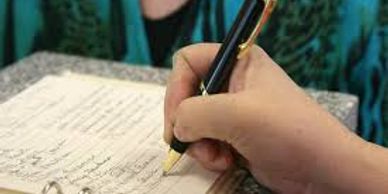 A picture of a person writing a note with a fancy pen