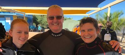 smiling scuba instructors with Peter