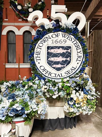 Circle Flower with a name written on it The town of Western Official seal