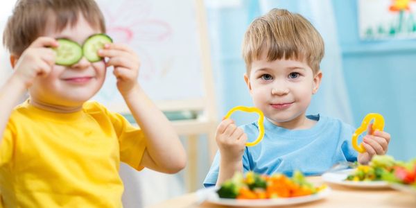 Children taking the lunch in a kinder garden