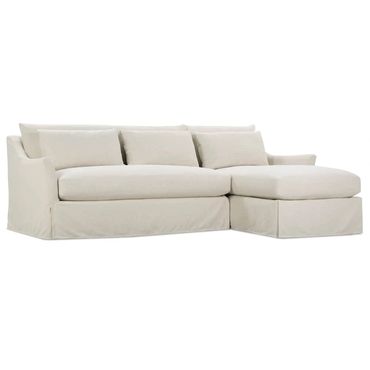 Minimalist beige sectional sofa with plush cushions and slipcover design.