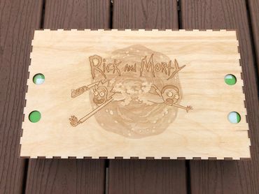 Rick and Morty logo and picture on wood chess box lid.