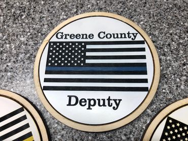 wood and acrylic coaster of US flag with blue stripe reading "greene county deputy".