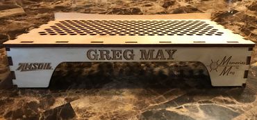 wood laptop stand with engraved name and ventilation holes.