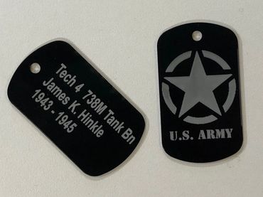 black metal military dog tag reading "tech 4 738M Tank Bn". Army star on reverse side.