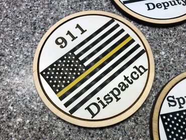 wood and acrylic coasters of US flag with yellow stripe reading "911 dispatch".