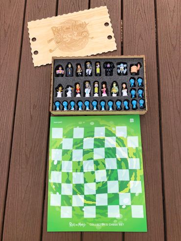 chess pieces in foam insert, Rick and Morty logo and picture on chess box lid.