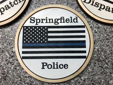wood and acrylic coaster of US flag with blue stripe reading "springfield police".