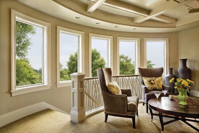 Cozy seating area with large windows overlooking greenery.