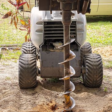 Auger hole drilling with a Bobcat