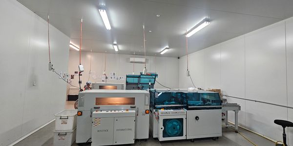 Shrink wrap line for dog treats. Optimised speed and labour savings. Reduced manual handling.